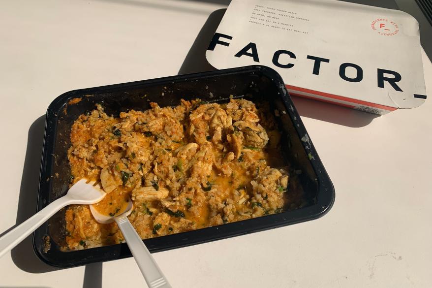 A fork and spoon on a plate of chicken